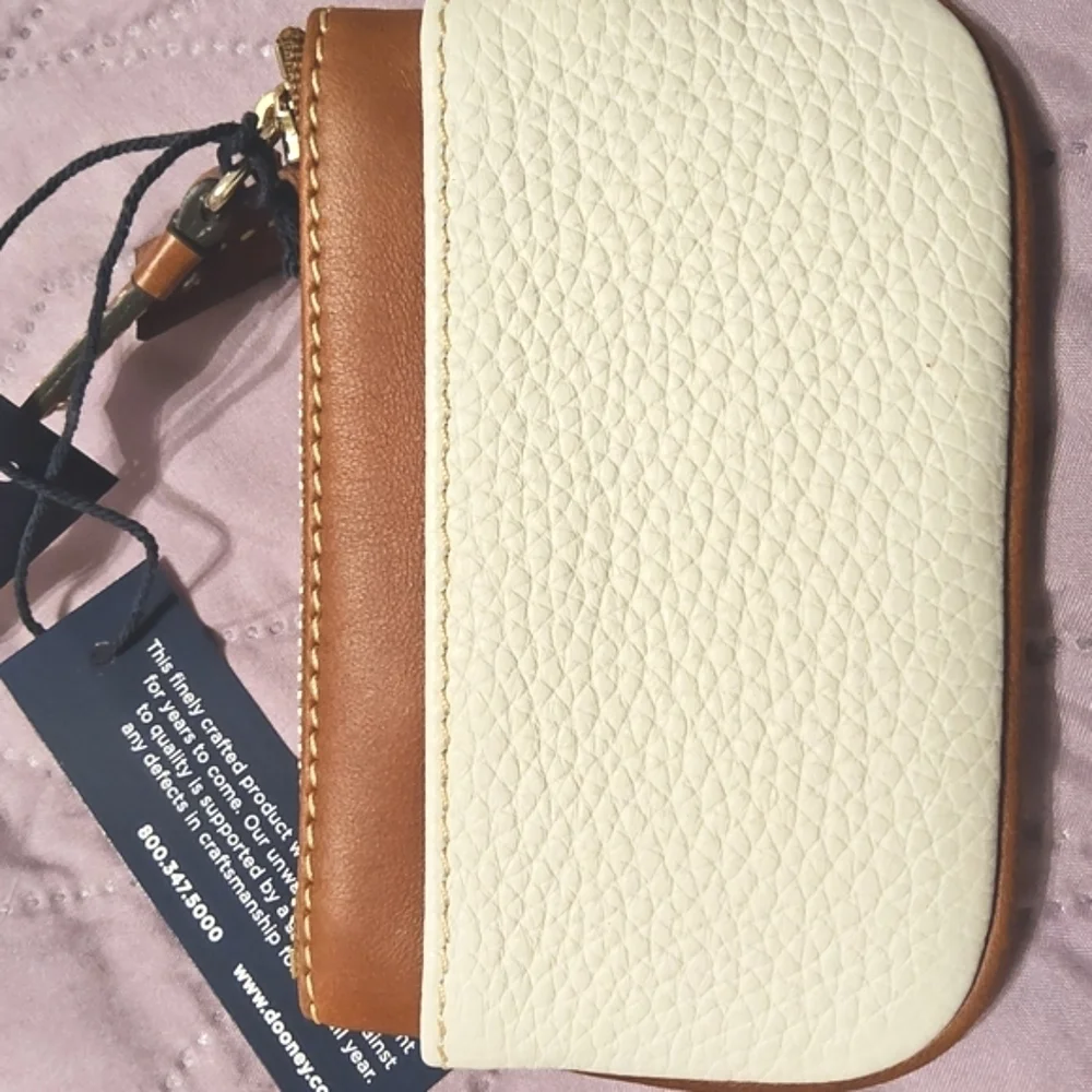 Dooney & Bourke White and Tan Clutch with Leather Trim.